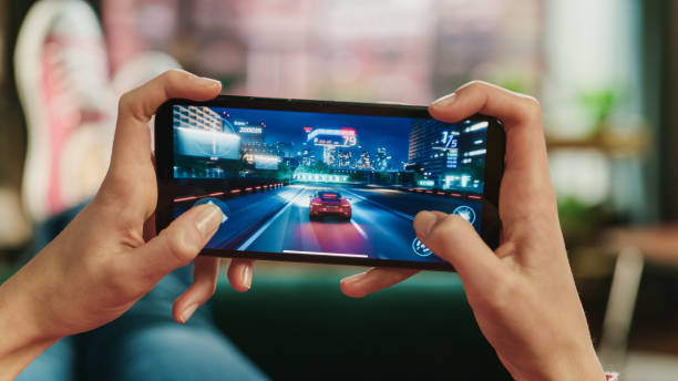 Smartphone displaying a fictional mobile game at an Australian gaming technology exhibition